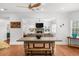 View of open floor plan with kitchen island into a living room with fireplace and plenty of sunlight at 2135 Glenfield Trce, Cumming, GA 30041