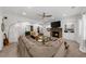 Comfortable living room boasts a stone fireplace, a large sectional sofa, and built-in bookshelves for a cozy ambiance at 2135 Glenfield Trce, Cumming, GA 30041