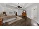 Spacious main bedroom boasts tray ceilings, a ceiling fan, and hardwood floors at 2135 Glenfield Trce, Cumming, GA 30041