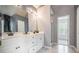 Bright bathroom with double sink vanity, modern fixtures, and large mirror at 3073 Hopeland Dr, Powder Springs, GA 30127