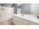 This bathroom features a shower/tub combo with a single sink and white cabinets at 3073 Hopeland Dr, Powder Springs, GA 30127