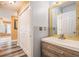 Stylish bathroom featuring a modern vanity with decorative mirror and wood-look floors at 3073 Hopeland Dr, Powder Springs, GA 30127