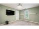 Clean bedroom with minimalist decor, a TV, and a decorative ceiling light fixture at 3073 Hopeland Dr, Powder Springs, GA 30127