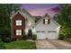 Charming two-story home with a brick accent, attached two car garage, and a well-manicured lawn at 3073 Hopeland Dr, Powder Springs, GA 30127