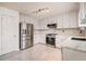 Modern kitchen with stainless steel appliances, marble countertops, and ample white cabinetry at 3073 Hopeland Dr, Powder Springs, GA 30127