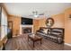 Cozy living room features a fireplace, ceiling fan, and hardwood floors, perfect for relaxation and entertaining at 3073 Hopeland Dr, Powder Springs, GA 30127