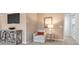 Comfortable sitting area with a chair, lamp, and TV; carpet flooring at 323 Silver Leaf Trce, Douglasville, GA 30134