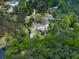 Aerial view of property surrounded by dense woods and an adjacent pond at 4445 Moon Station Nw Ln, Acworth, GA 30101
