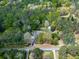 Aerial view of the sprawling property surrounded by lush greenery and mature trees at 4445 Moon Station Nw Ln, Acworth, GA 30101