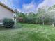 View of house with a beautiful backyard with green grass and many trees at 4445 Moon Station Nw Ln, Acworth, GA 30101