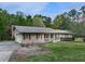 Attractive home with a covered entrance, attached garage, and lush lawn in a tranquil, wooded neighborhood at 4445 Moon Station Nw Ln, Acworth, GA 30101