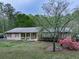 Attractive home with red shutters, a covered porch, and flowering trees accenting the meticulously kept lawn at 4445 Moon Station Nw Ln, Acworth, GA 30101