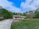 Charming home featuring a covered porch and well-manicured lawn, framed by lush greenery and trees at 4445 Moon Station Nw Ln, Acworth, GA 30101