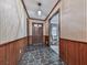 Front hallway with stone floors and wood paneled walls at 4445 Moon Station Nw Ln, Acworth, GA 30101