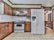 Traditional kitchen features wooden cabinets, white appliances, and tile flooring at 4445 Moon Station Nw Ln, Acworth, GA 30101