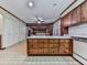 Traditional kitchen with wood cabinets, a center island, and tile floors at 4445 Moon Station Nw Ln, Acworth, GA 30101