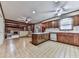 Traditional kitchen featuring wood cabinets, an island, and open access to the living area at 4445 Moon Station Nw Ln, Acworth, GA 30101
