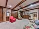 Living room with wood walls and beams with fireplace and large ceiling fan at 4445 Moon Station Nw Ln, Acworth, GA 30101