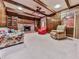 Living room with wood walls and beams with fireplace and large ceiling fan at 4445 Moon Station Nw Ln, Acworth, GA 30101