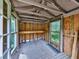 Enclosed porch with natural light, exposed beams, and wood plank flooring at 4445 Moon Station Nw Ln, Acworth, GA 30101