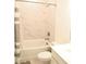 Bathroom featuring marble-style tile, shower, and tub with updated fixtures at 4734 Dewitt Dr, Duluth, GA 30097