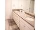 This bathroom boasts dual sinks with quartz countertops and white cabinets at 4734 Dewitt Dr, Duluth, GA 30097