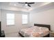 Bright bedroom featuring a queen-sized bed, tray ceiling, and neutral decor at 4734 Dewitt Dr, Duluth, GA 30097