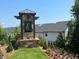 Stone community entrance sign with the letter 'E' and manicured landscaping at 4734 Dewitt Dr, Duluth, GA 30097