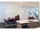 Dining area with modern chandelier, wooden table, seamlessly connecting kitchen and living spaces at 4734 Dewitt Dr, Duluth, GA 30097