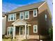 Beautiful two-story home with brown siding, a covered porch, and well-maintained landscaping at 4734 Dewitt Dr, Duluth, GA 30097