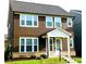 Two-story home showcasing a brown shingle facade and a welcoming front porch at 4734 Dewitt Dr, Duluth, GA 30097