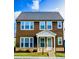 Inviting two-story home boasts a charming facade with well-manicured lawn at 4734 Dewitt Dr, Duluth, GA 30097