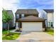Rear view of this house highlighting the attached two car garage and paved driveway at 4734 Dewitt Dr, Duluth, GA 30097