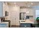 Well-lit kitchen features stainless steel appliances, white cabinets, and gray backsplash at 4734 Dewitt Dr, Duluth, GA 30097