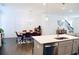 Sunlit open-concept kitchen featuring a dining area and hardwood floors at 4734 Dewitt Dr, Duluth, GA 30097