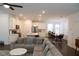 Spacious open-concept living area with modern decor, flowing into a dining area and kitchen at 4734 Dewitt Dr, Duluth, GA 30097