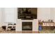 Cozy living room featuring a modern fireplace, large screen television and light-filled windows at 4734 Dewitt Dr, Duluth, GA 30097