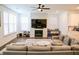 Bright living room with a modern fireplace and large sectional sofa, offering cozy living space at 4734 Dewitt Dr, Duluth, GA 30097