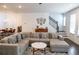 Inviting living room with a large sectional sofa and easy access to the staircase at 4734 Dewitt Dr, Duluth, GA 30097
