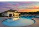 Community pool area featuring a pool house and lounge chairs under a beautiful sunset at 4734 Dewitt Dr, Duluth, GA 30097