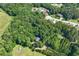 Overhead shot displaying a home site that is surrounded by mature trees and nearby residential neighborhoods at 558 Auburn Rd, Auburn, GA 30011
