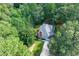 Aerial shot of house boasting mature trees and a well-manicured lawn with direct driveway access at 558 Auburn Rd, Auburn, GA 30011