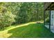 Lush backyard with mature trees, offering privacy and natural beauty at 558 Auburn Rd, Auburn, GA 30011