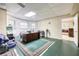 Basement area with drop ceiling, furniture, rug and bright windows at 558 Auburn Rd, Auburn, GA 30011