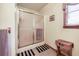 Enclosed shower with sliding glass door in this quaint bathroom setting at 558 Auburn Rd, Auburn, GA 30011