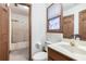 Bathroom with a walk-in shower and a large vanity with a solid surface counter at 558 Auburn Rd, Auburn, GA 30011