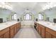 Bathroom with double vanity sinks and a central soaking tub beneath a vaulted ceiling at 558 Auburn Rd, Auburn, GA 30011