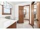 A clean bathroom with a window and views of an open toilet and wardrobe at 558 Auburn Rd, Auburn, GA 30011