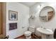 Traditional bathroom featuring a pedestal sink, round mirror, and neutral decor at 558 Auburn Rd, Auburn, GA 30011