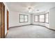 Bright bedroom with bay windows, neutral carpet, and a ceiling fan for added comfort at 558 Auburn Rd, Auburn, GA 30011